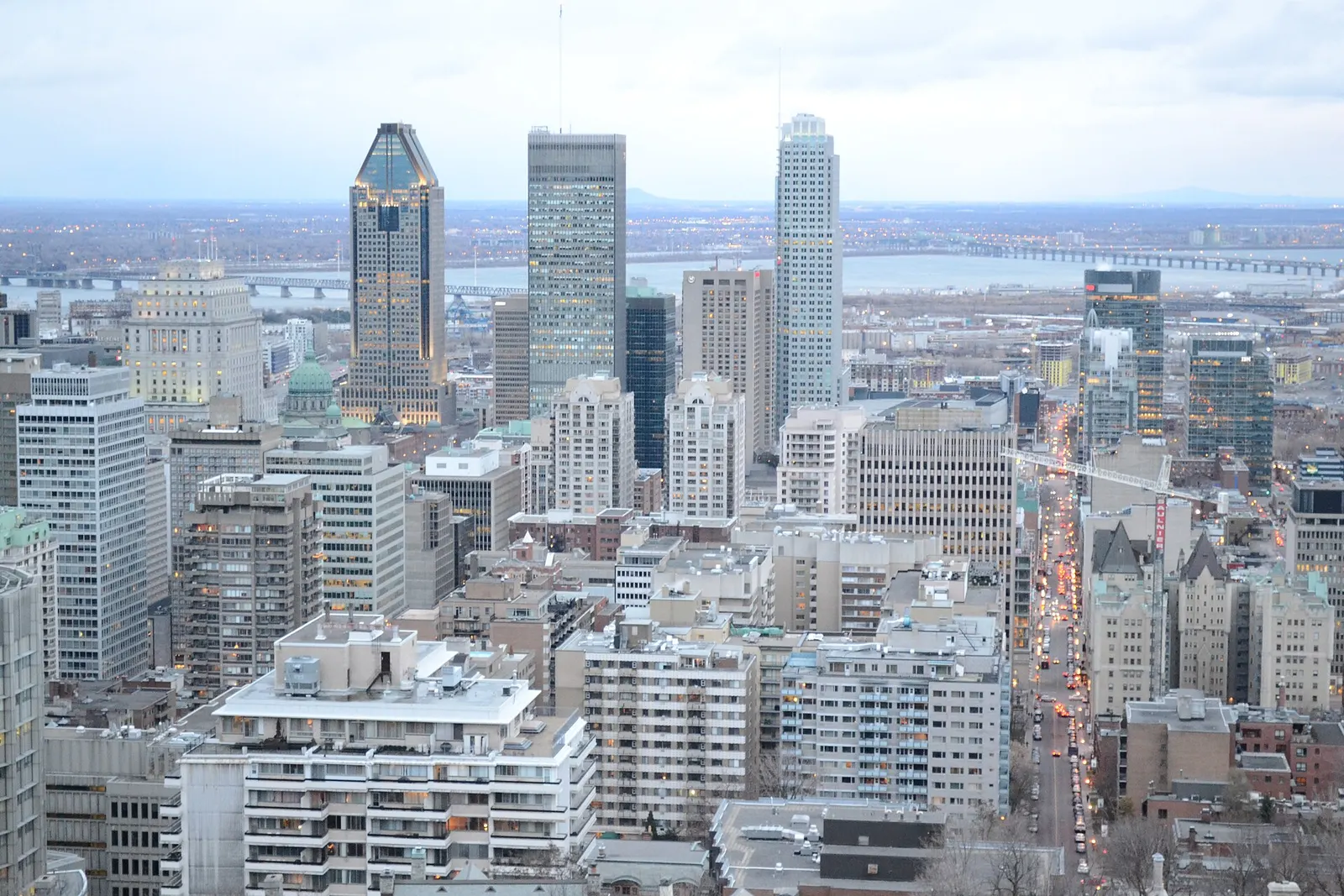 The downtown Montreal skyline of towers seen from Mount Royal above the green trees