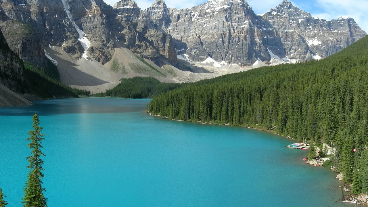 Turquoise Moraine Lake below the Valley of the Ten Peaks with canoes at the dock