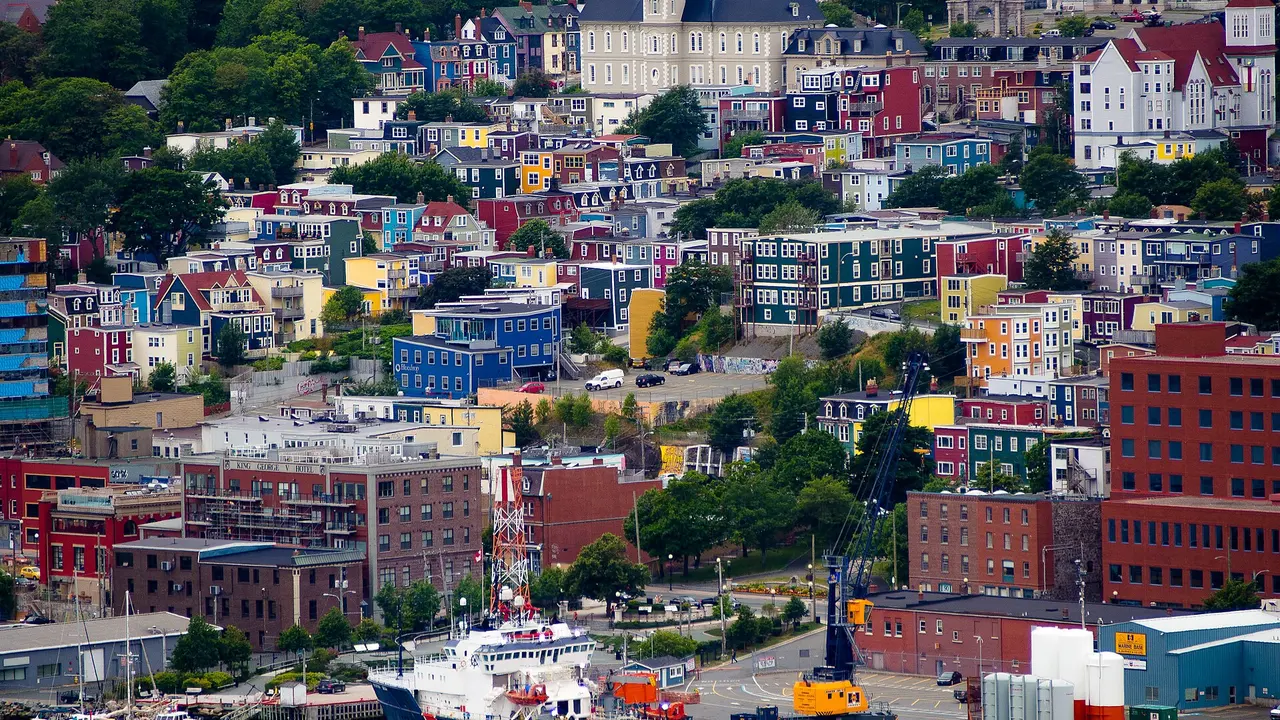 A hillside of brightly painted row houses in downtown St. John's above the harbour