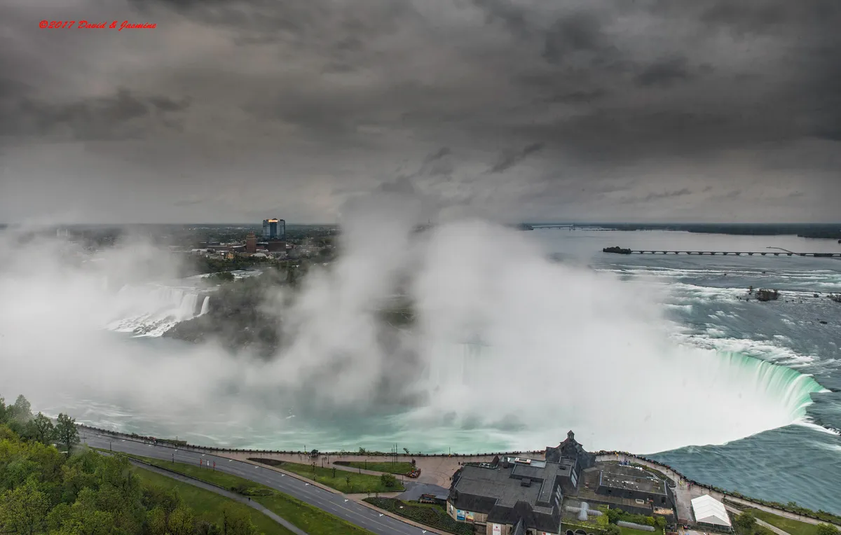 Mist rising from the curved green crest of the Horseshoe Falls at Niagara