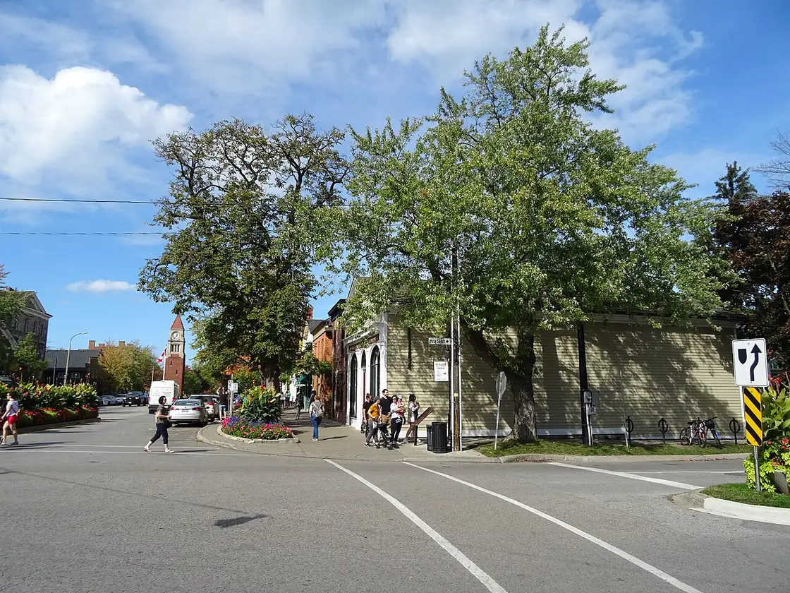 The white-painted brick facade of the historic Niagara Apothecary building at 5 Queen Street, Niagara-on-the-Lake