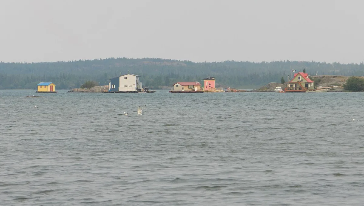 Brightly coloured houseboats moored on Great Slave Lake in the Old Town of Yellowknife