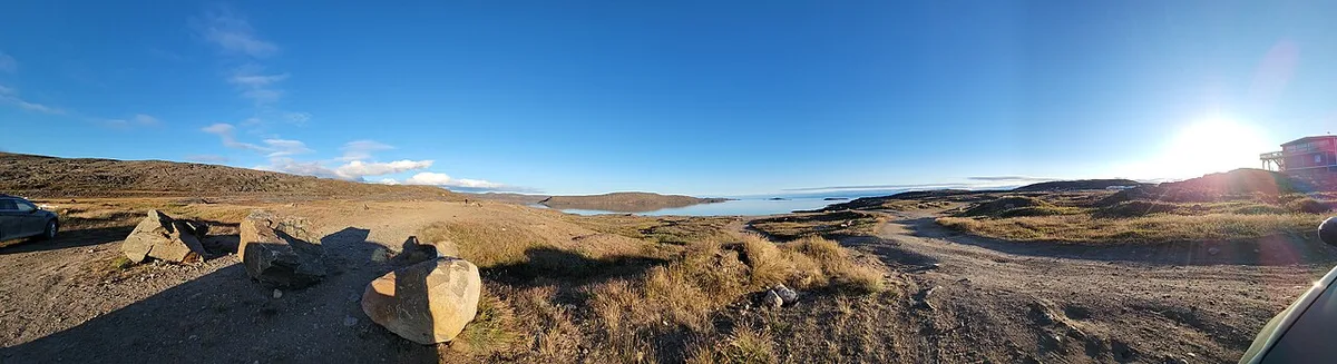 The town of Iqaluit and the community of Apex spread along the shore of Frobisher Bay under a wide sky