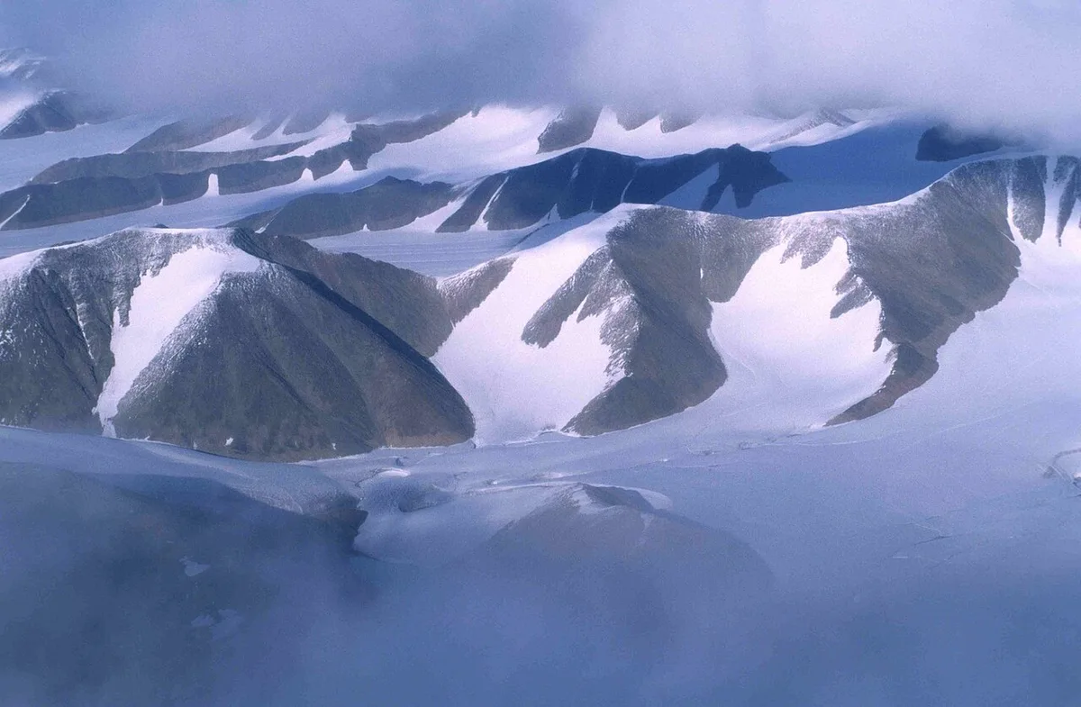 The snow-capped Byam Martin Mountains rising above the coast of Bylot Island in Sirmilik National Park