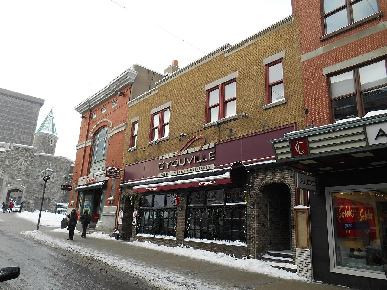 Rue Saint-Jean in Old Quebec with the stone Porte Saint-Jean gate visible in the background