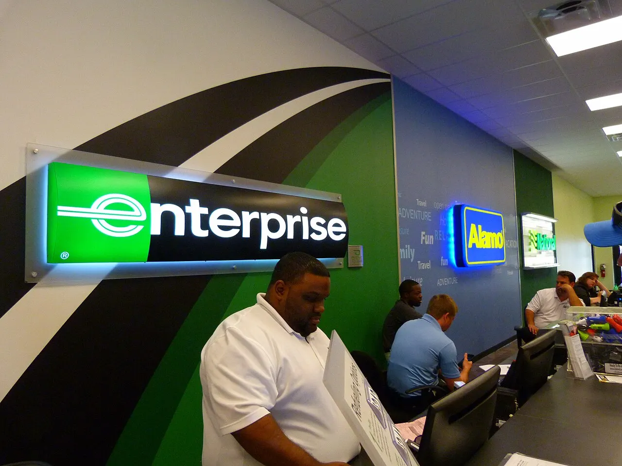 A shared Enterprise, Alamo and National Car Rental counter at an airport terminal