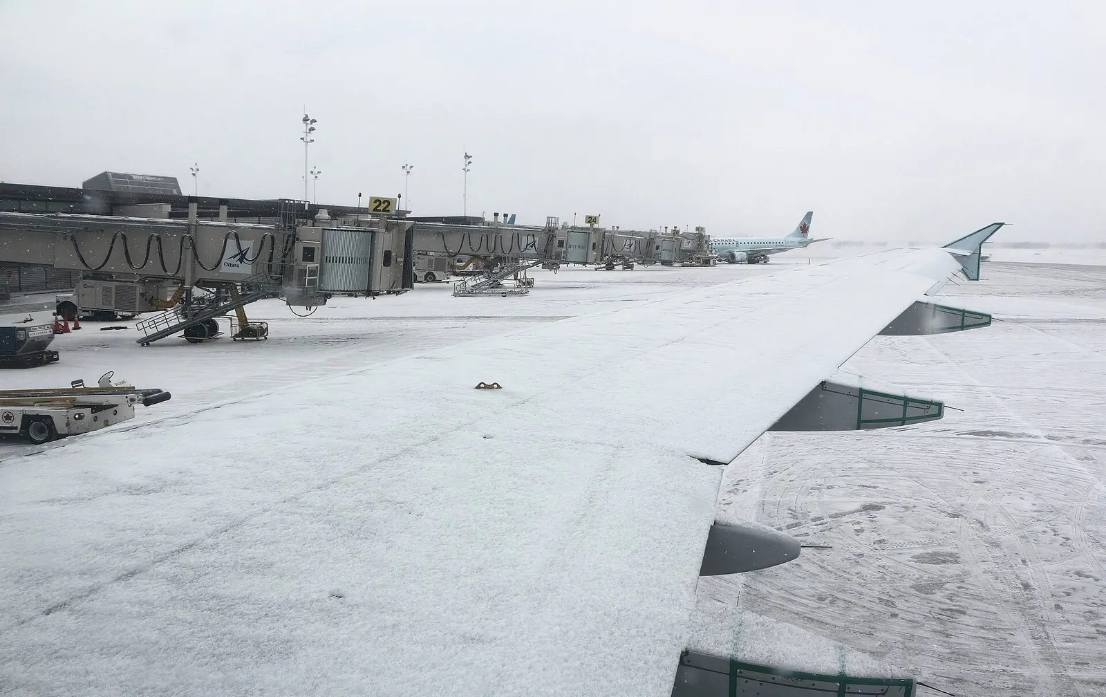 Snow-covered Ottawa Macdonald-Cartier International Airport apron and terminal in winter