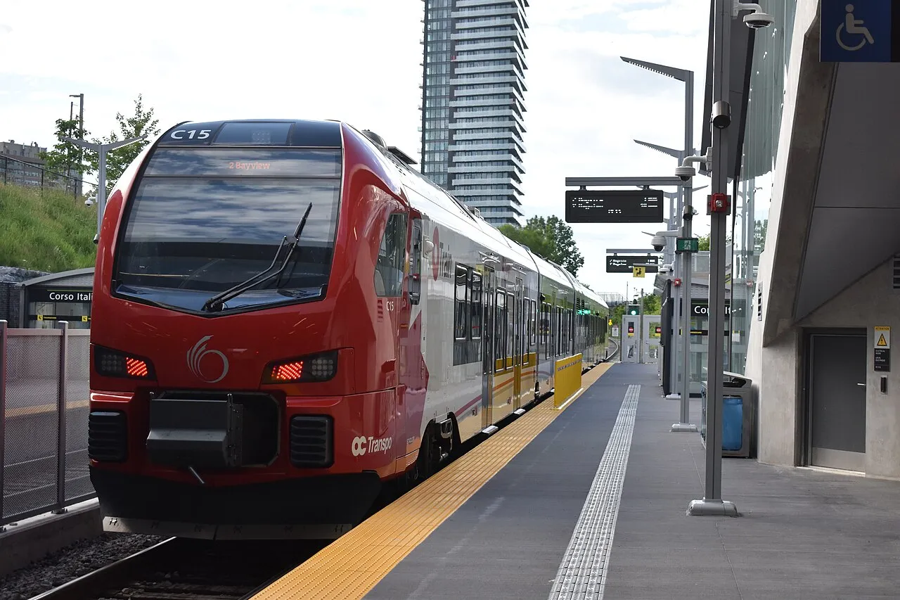 An O-Train Line 2 Stadler FLIRT train stopped at Corso Italia Station