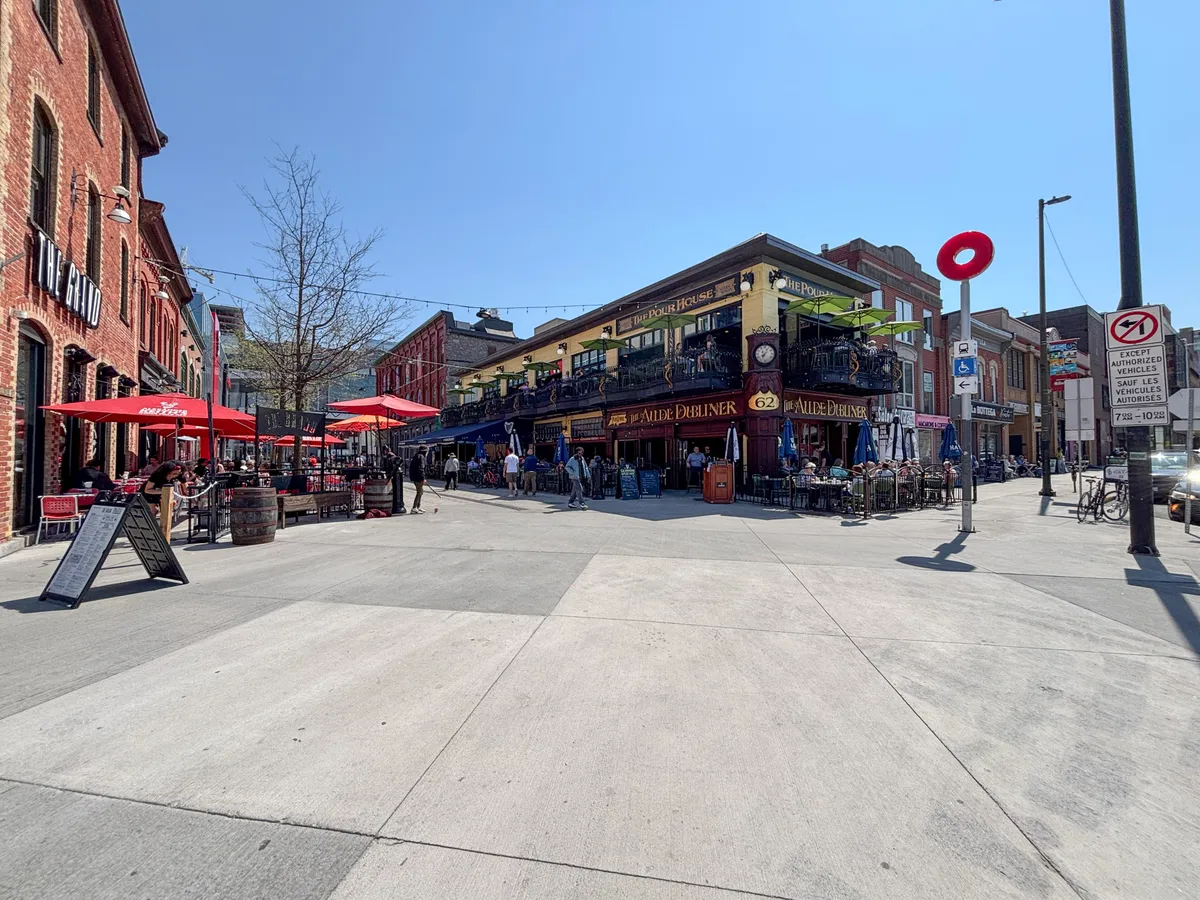 People walking a pedestrianised street lined with shops in the ByWard Market district of Ottawa