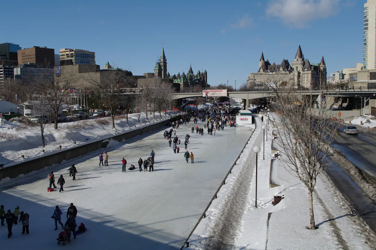 Skaters on the frozen Rideau Canal below the Château Laurier and Parliament in Ottawa