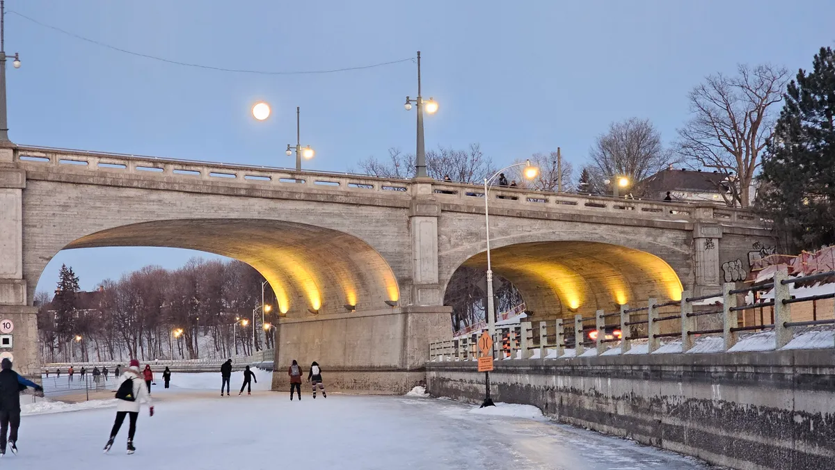 A cleared strip of the Rideau Canal Skateway passing under the Bank Street Bridge in March