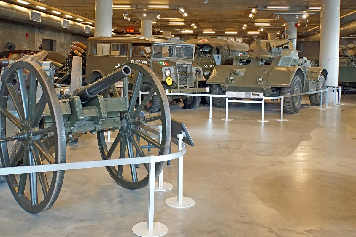 Military vehicles and equipment displayed in a large hall at the Canadian War Museum