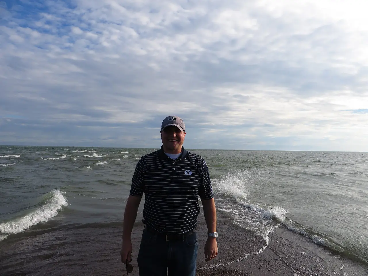 A visitor standing at the marker for the southernmost point of mainland Canada at Point Pelee
