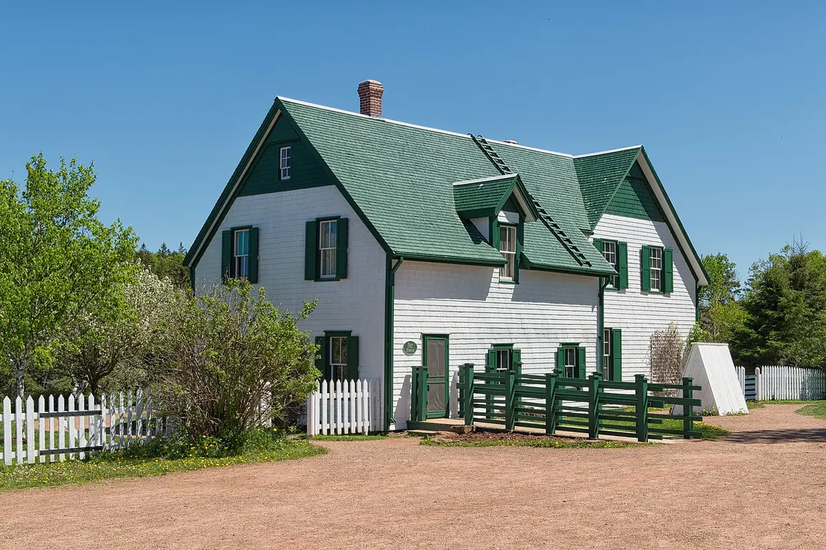 The green-and-white gabled farmhouse at Green Gables Heritage Place in Cavendish, backed by trees