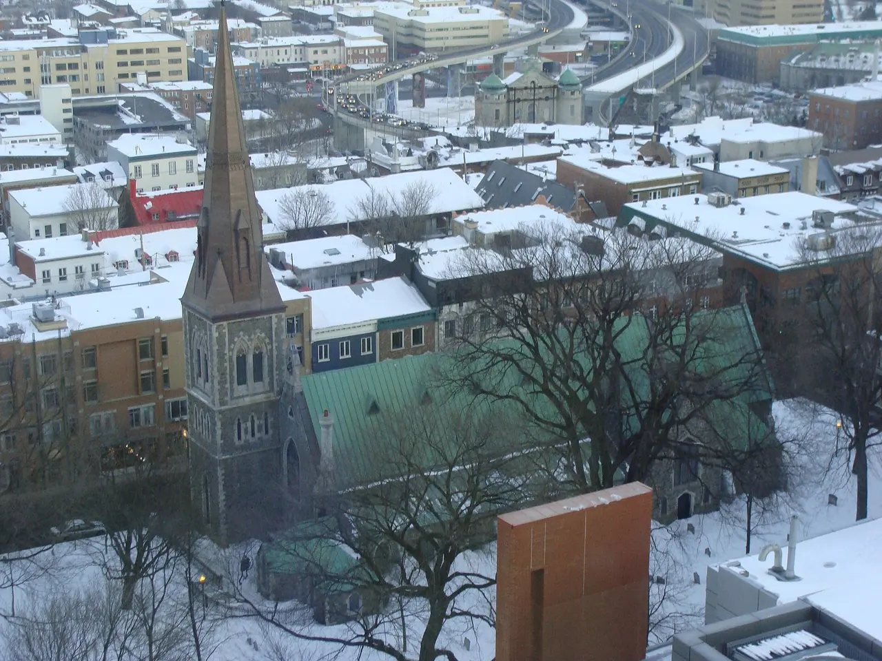 Quebec City rooftops and the St Lawrence seen in winter from a high hotel window