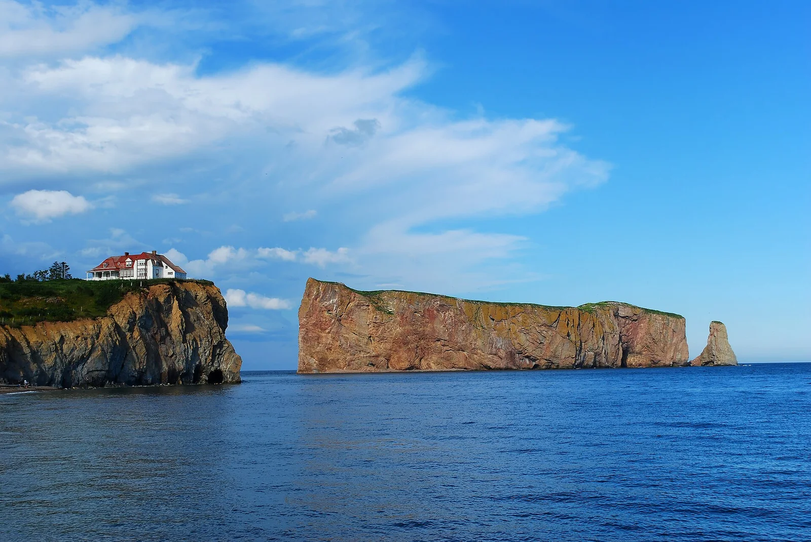 Percé Rock rising out of the sea off the Gaspé Peninsula under a grey sky