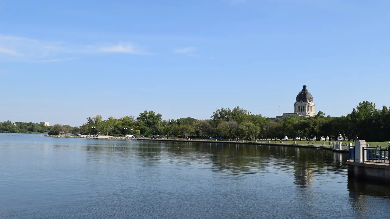 The domed Saskatchewan Legislative Building reflected across Wascana Lake in Regina