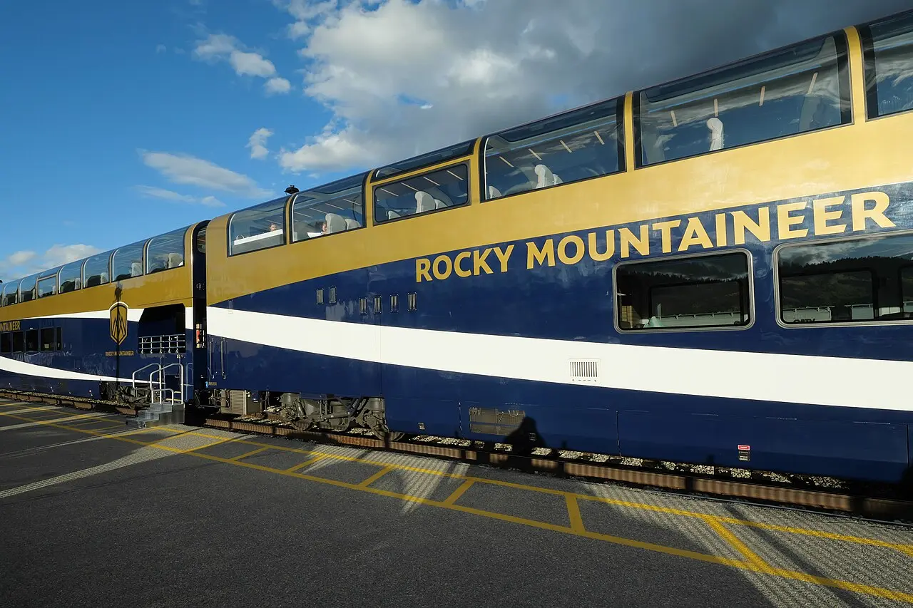 Rocky Mountaineer coaches under cloudy skies at Jasper in the Rockies