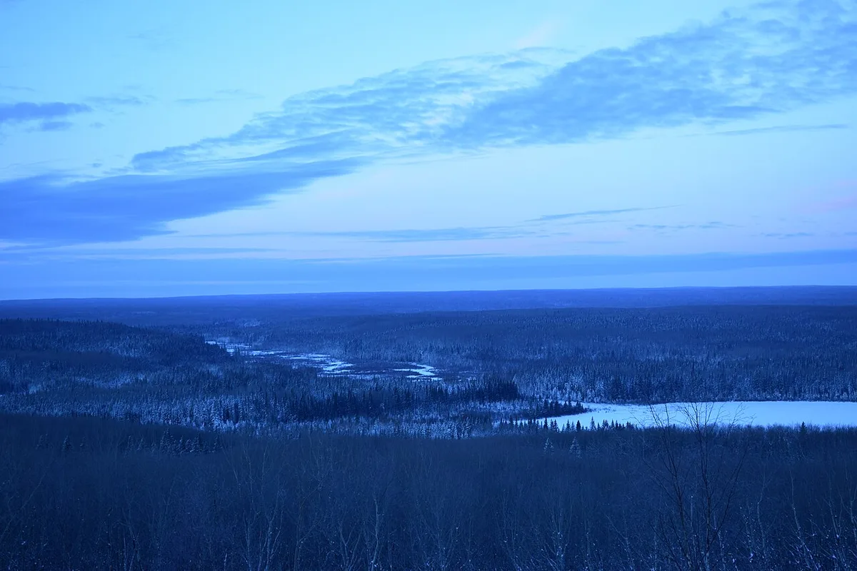 A patchwork of boreal forest and blue lakes seen from the Height of Land viewing tower in Prince Albert National Park