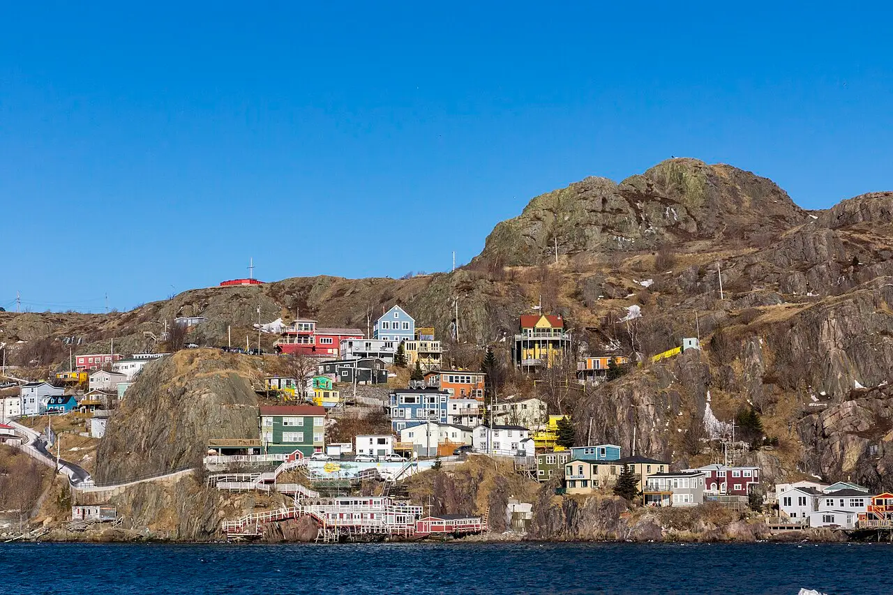 Colourful wooden houses of The Battery stacked above St. John's harbour mouth