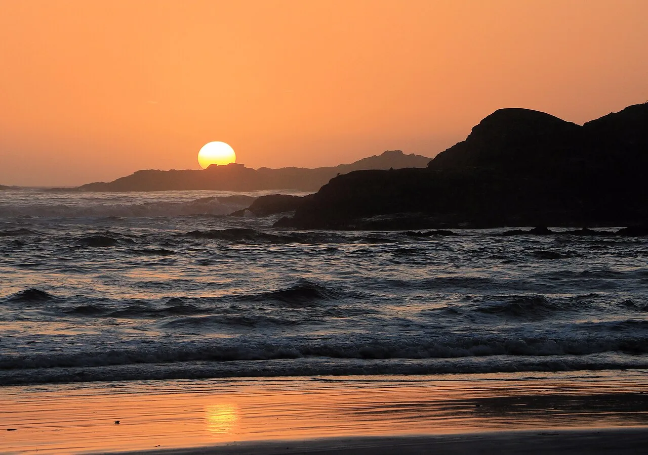 Sunset light over the surf and rock at Cox Bay near Tofino