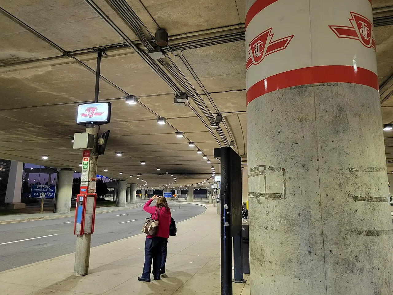 A TTC bus stop under the Terminal 1 roadway at Toronto Pearson airport