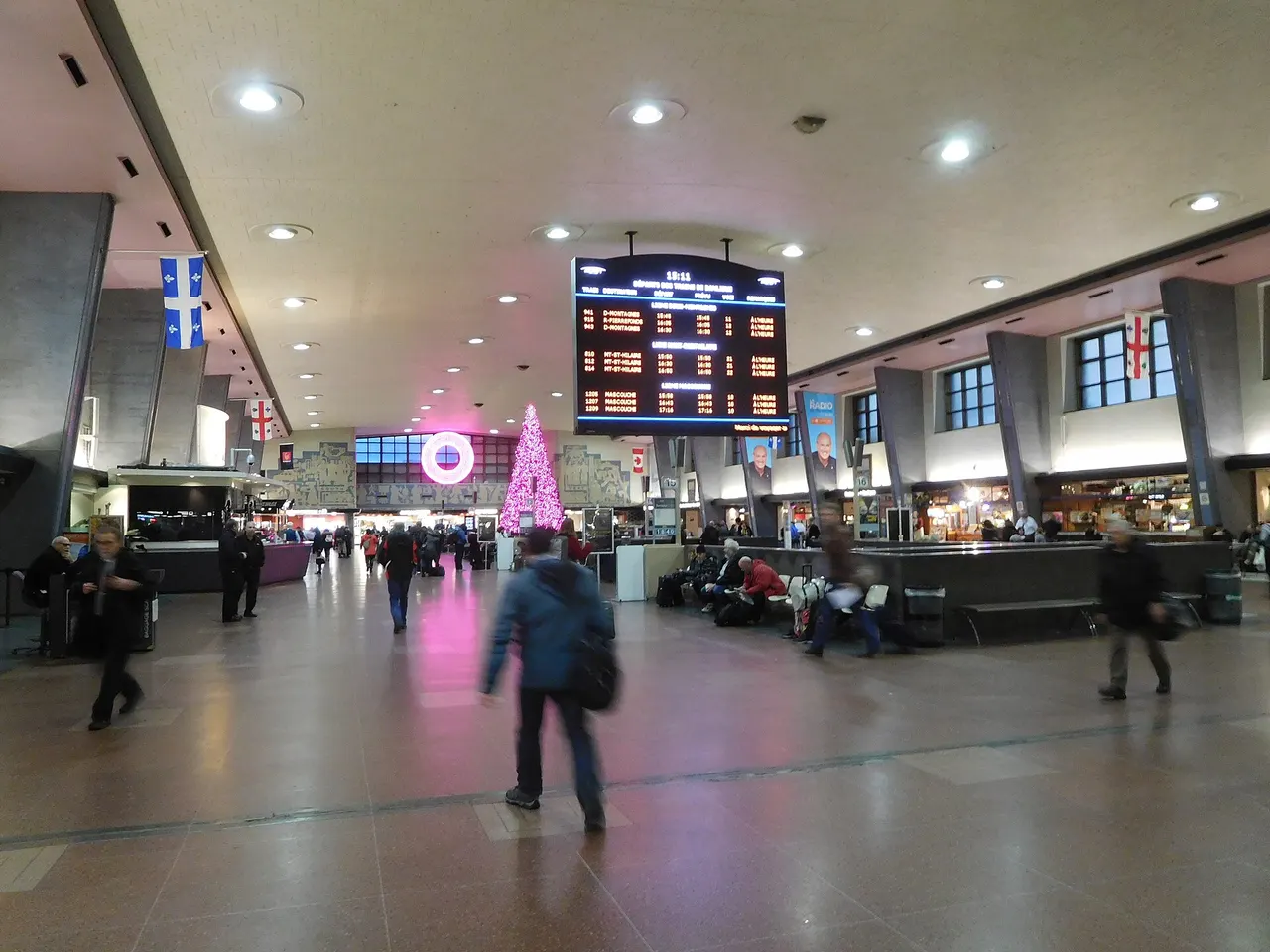 Interior hall of Montreal Gare Centrale with departure boards and passengers