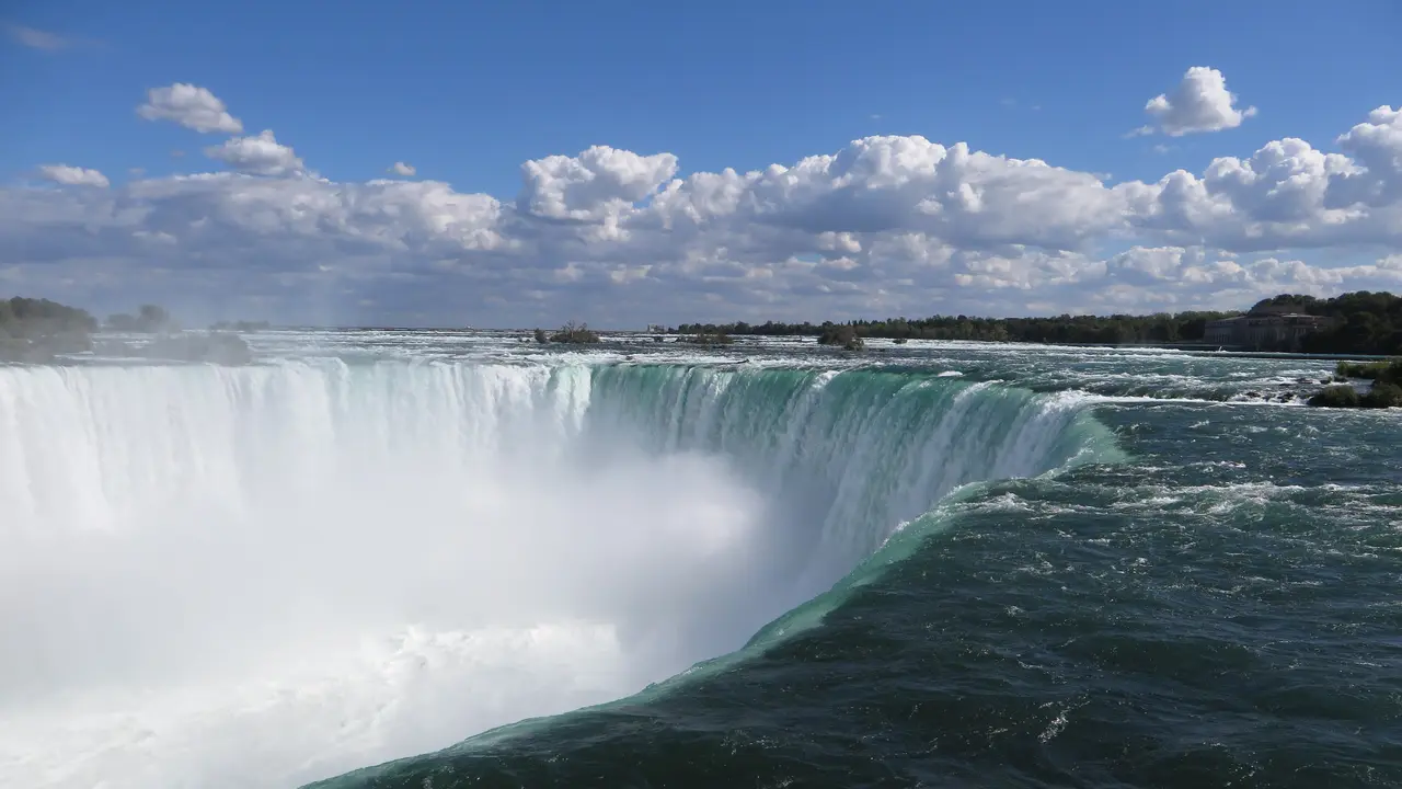 The Canadian Horseshoe Falls seen from the Ontario side with mist rising from the base of the curve