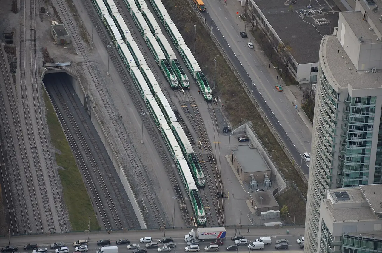 Green and white GO Transit double-decker trains lined up under the platform sheds at Toronto Union Station