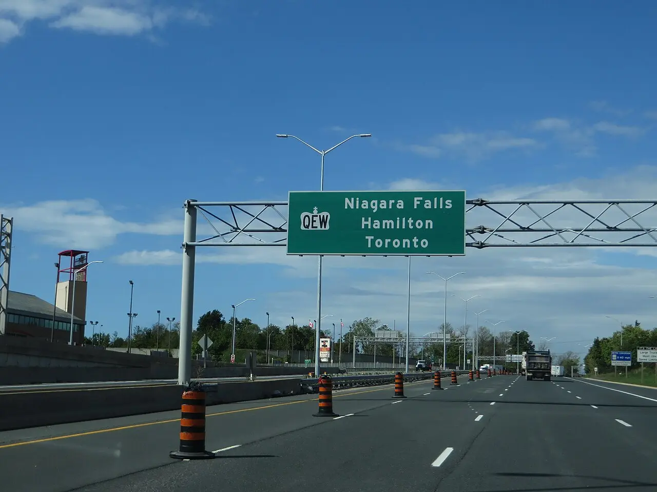 Traffic on the multi-lane Queen Elizabeth Way between Hamilton and Fort Erie under a blue sky