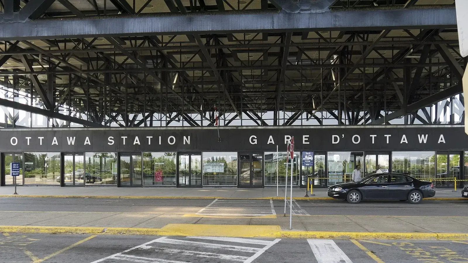 Wide view of Ottawa station platforms and the modern station canopy under a clear sky