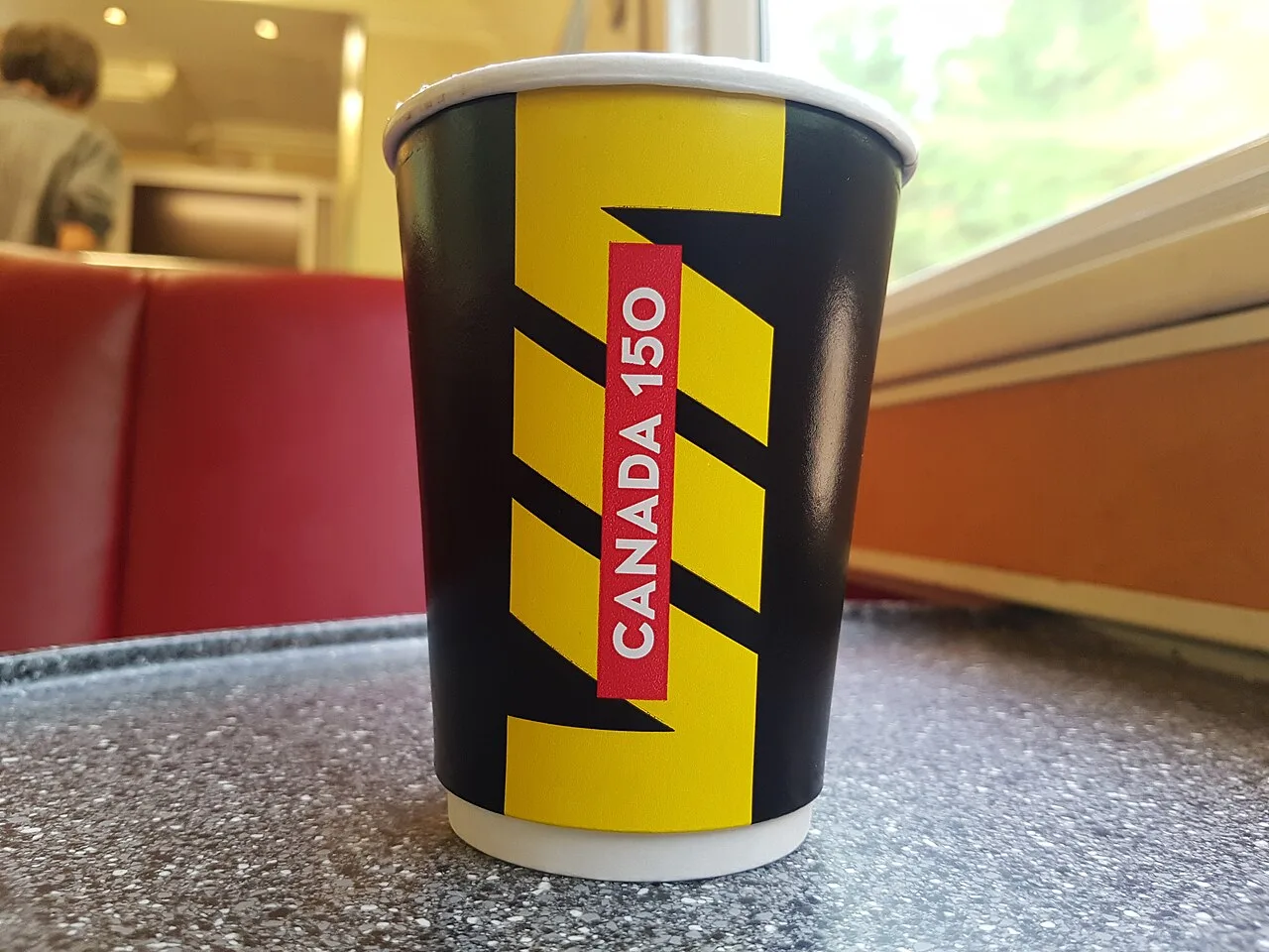 VIA Rail Corridor train stopped at a station platform with passengers nearby