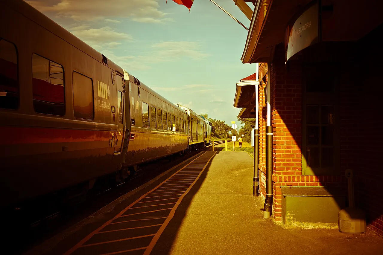 A VIA Rail Corridor train passing through open countryside