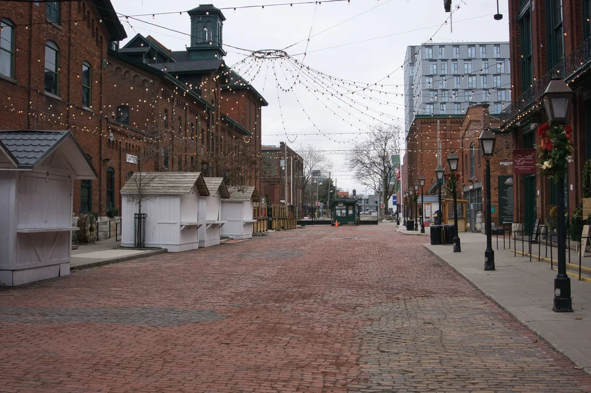 Red-brick Victorian industrial buildings lining pedestrian Trinity Street in the Distillery District