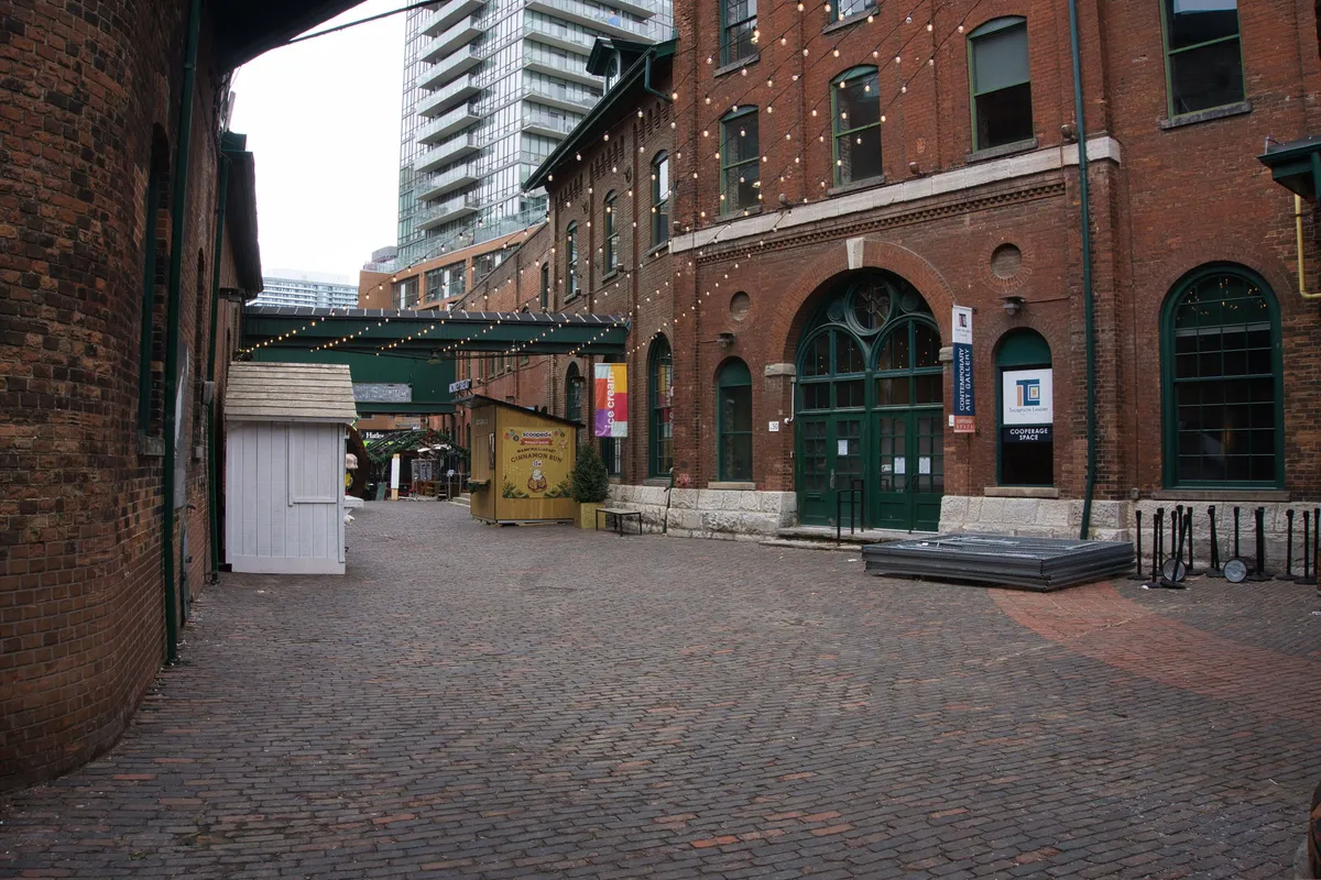 Cobbled Gristmill Lane between old brick buildings in the Distillery Historic District