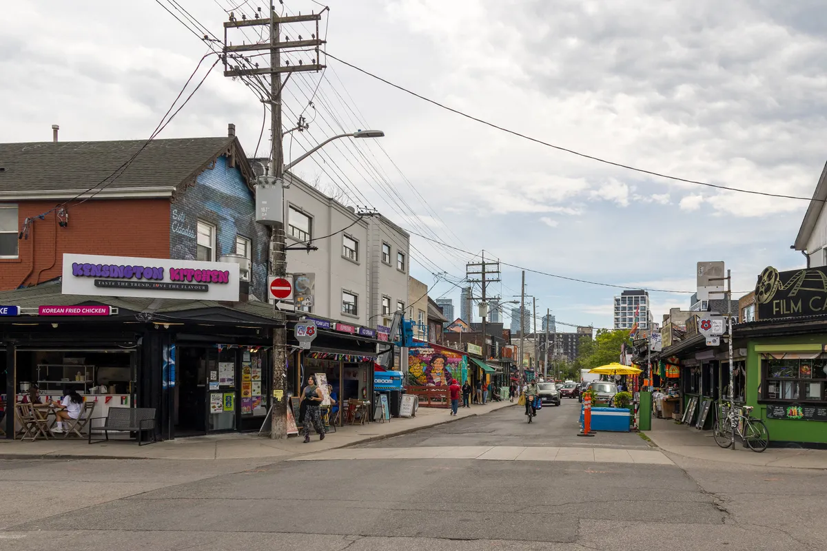 Colourful shopfronts and pedestrians on Augusta Avenue in Kensington Market