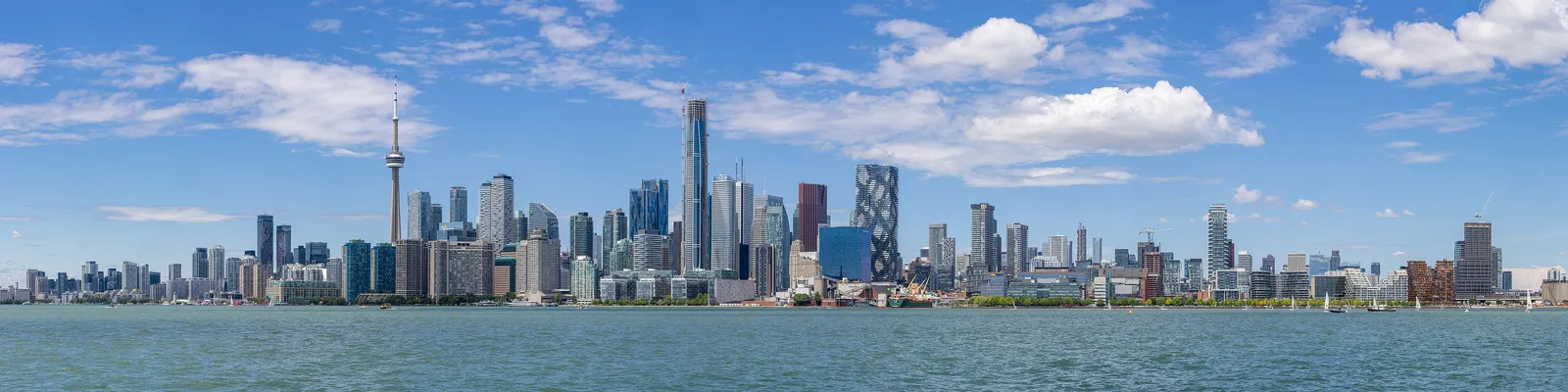 The full Toronto skyline seen across the water from Ward's Island, the CN Tower at its centre
