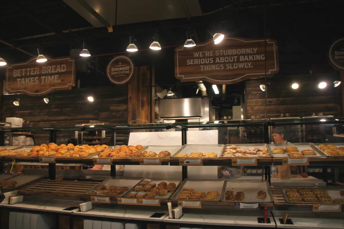 Food stalls and shoppers inside the South Market hall at St. Lawrence Market