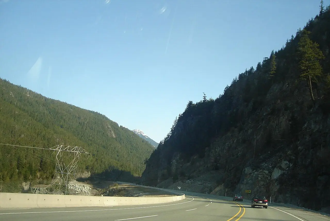 Highway 99 curving toward forested mountains near Squamish