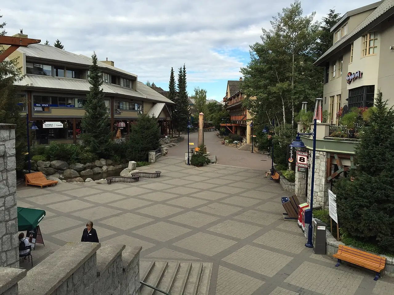 Pedestrian lanes and mountain backdrop in Whistler Village on a clear day