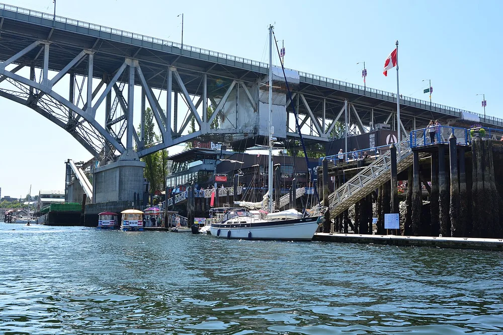 A small brightly coloured Aquabus ferry at the Granville Island dock on False Creek