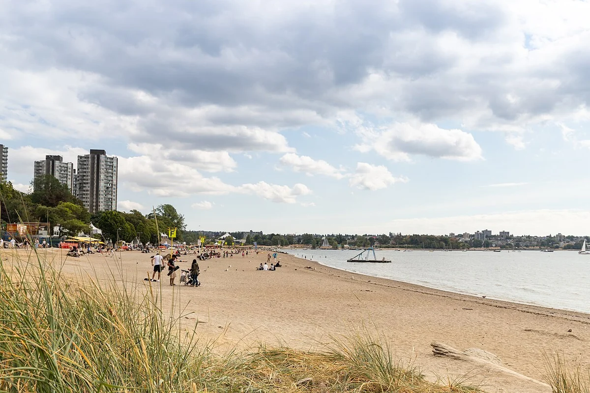 Sand, swimmers and the West End skyline behind English Bay Beach in Vancouver