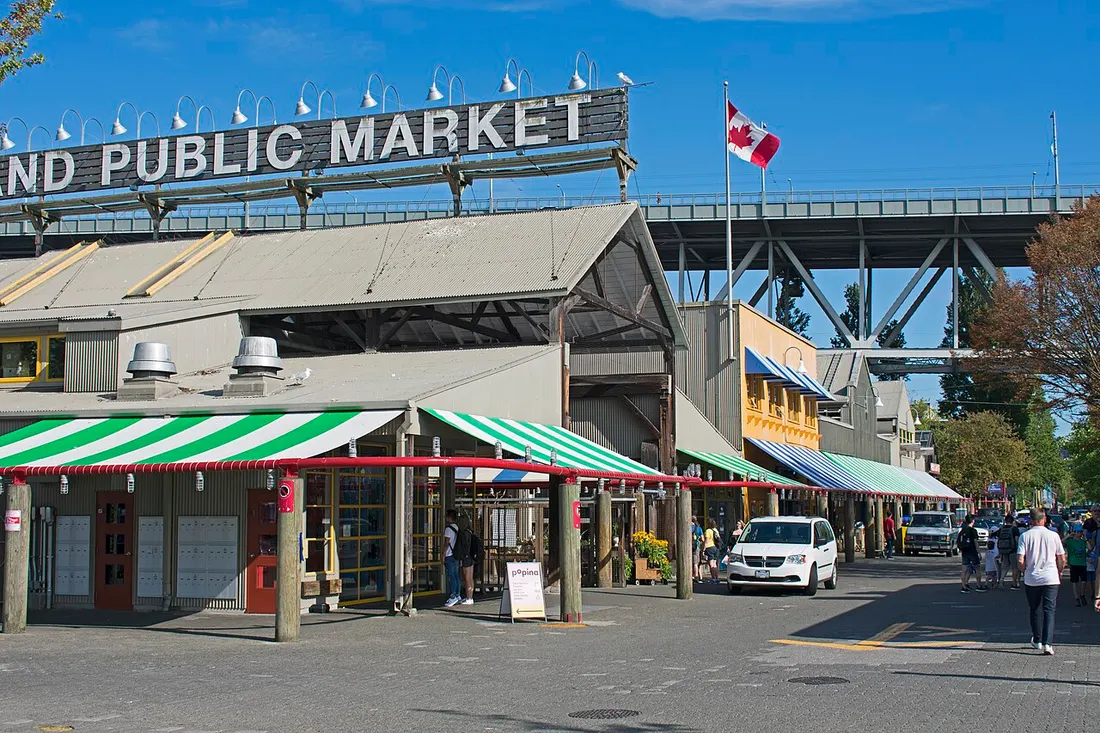 The Granville Island Public Market building with the Granville Bridge rising behind it