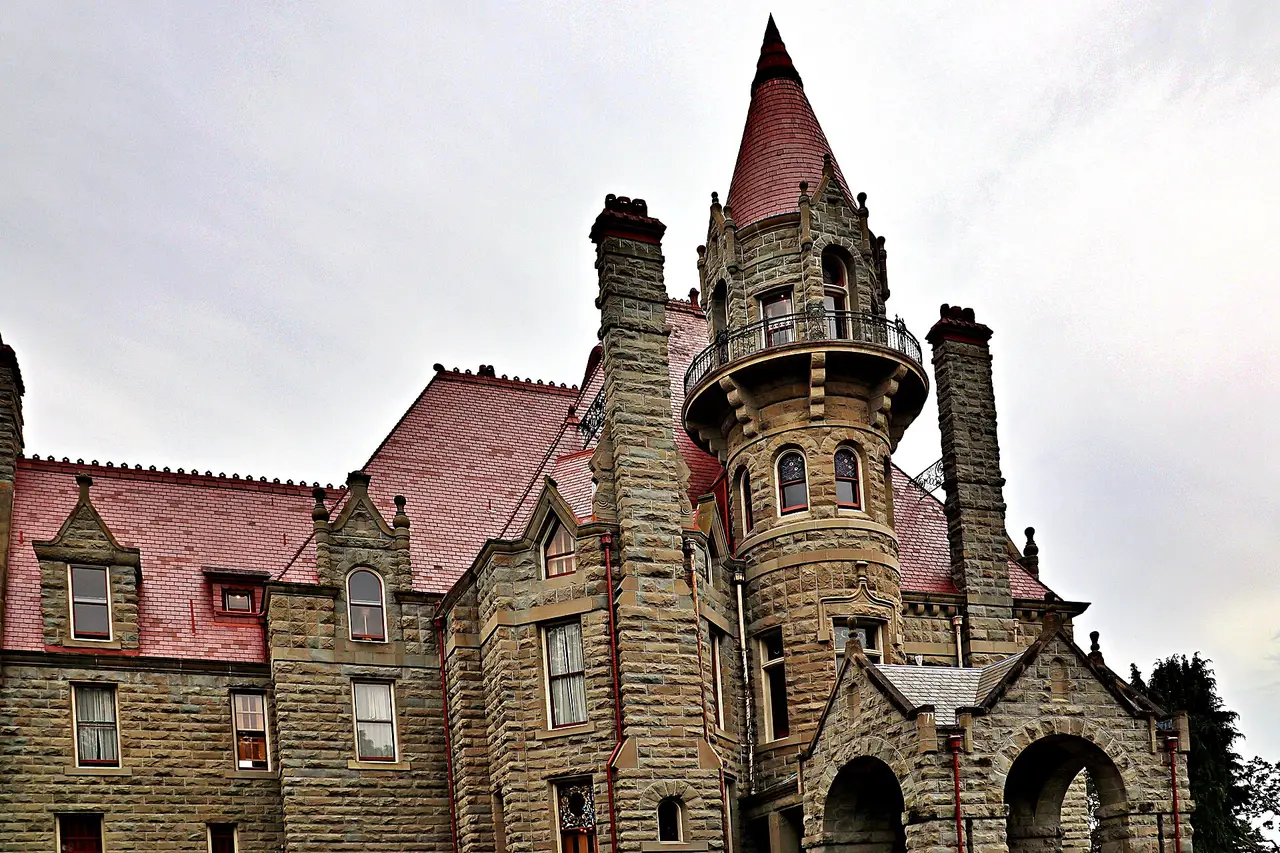 The stone turrets of Craigdarroch Castle rising above the trees in Victoria