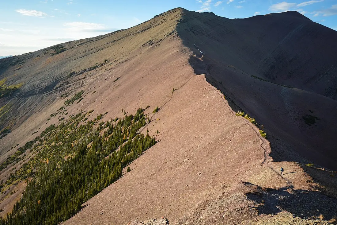 Hikers on an alpine section of the Carthew-Alderson Trail above the Carthew Lakes in Waterton Lakes National Park
