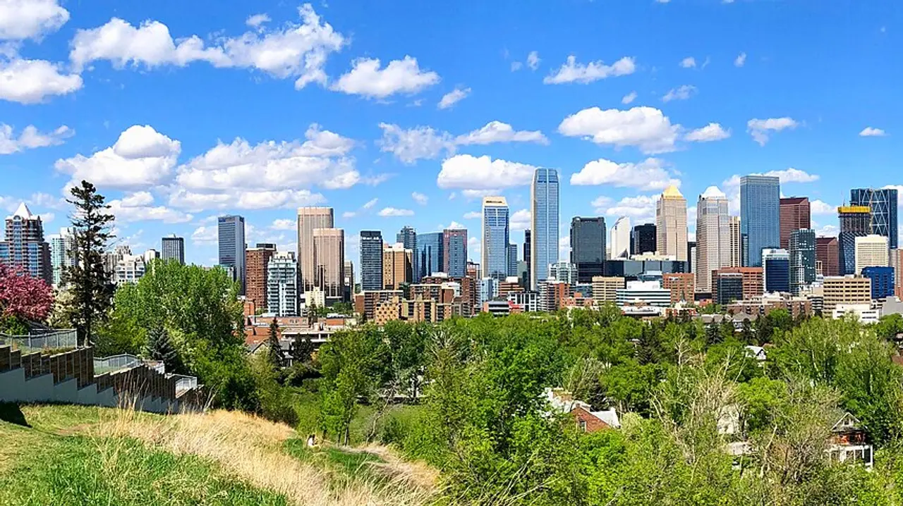 The downtown Calgary skyline stretched across the prairie under a blue sky
