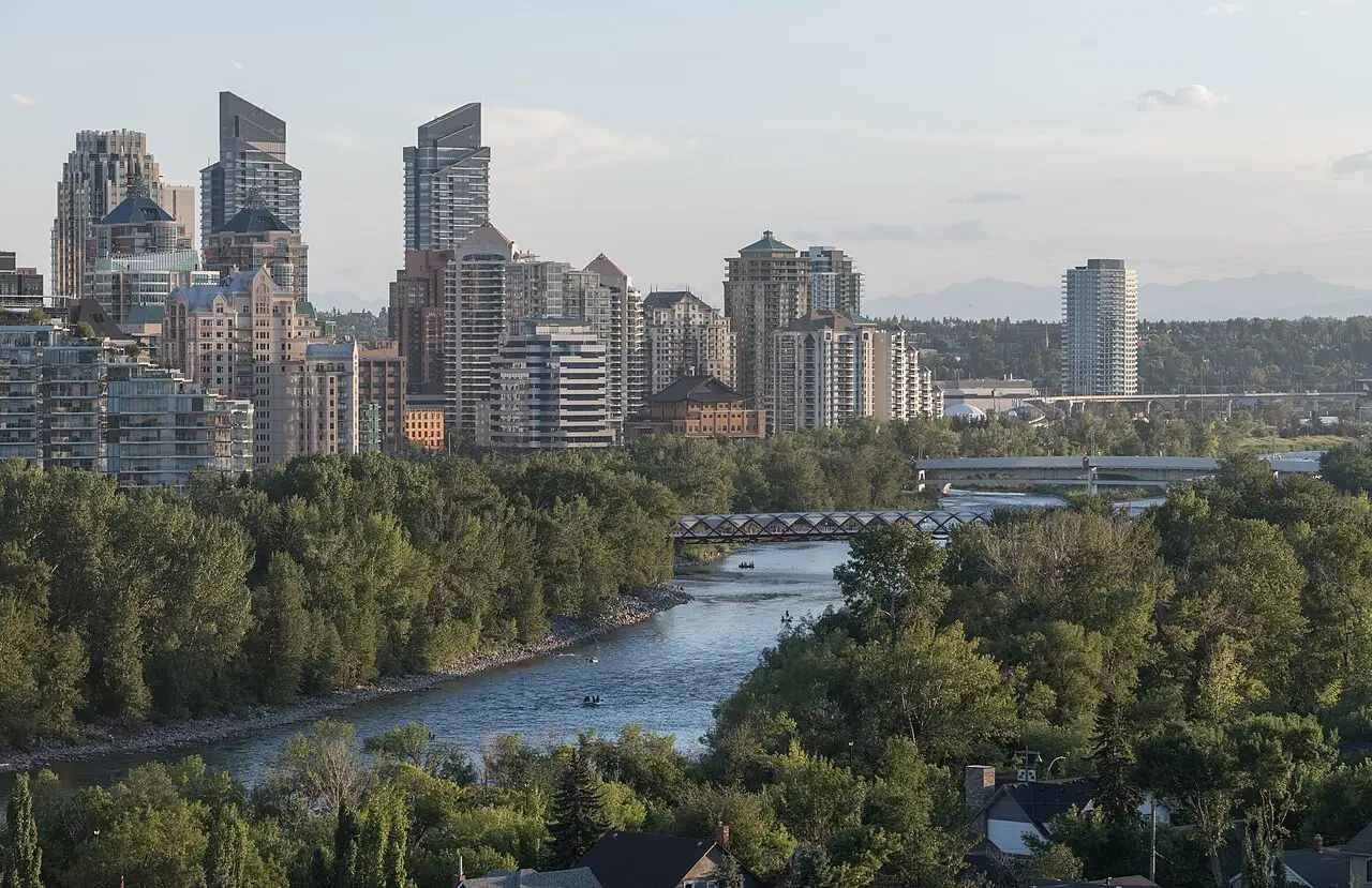 The white tubular Peace Bridge spanning the Bow River with downtown Calgary behind it