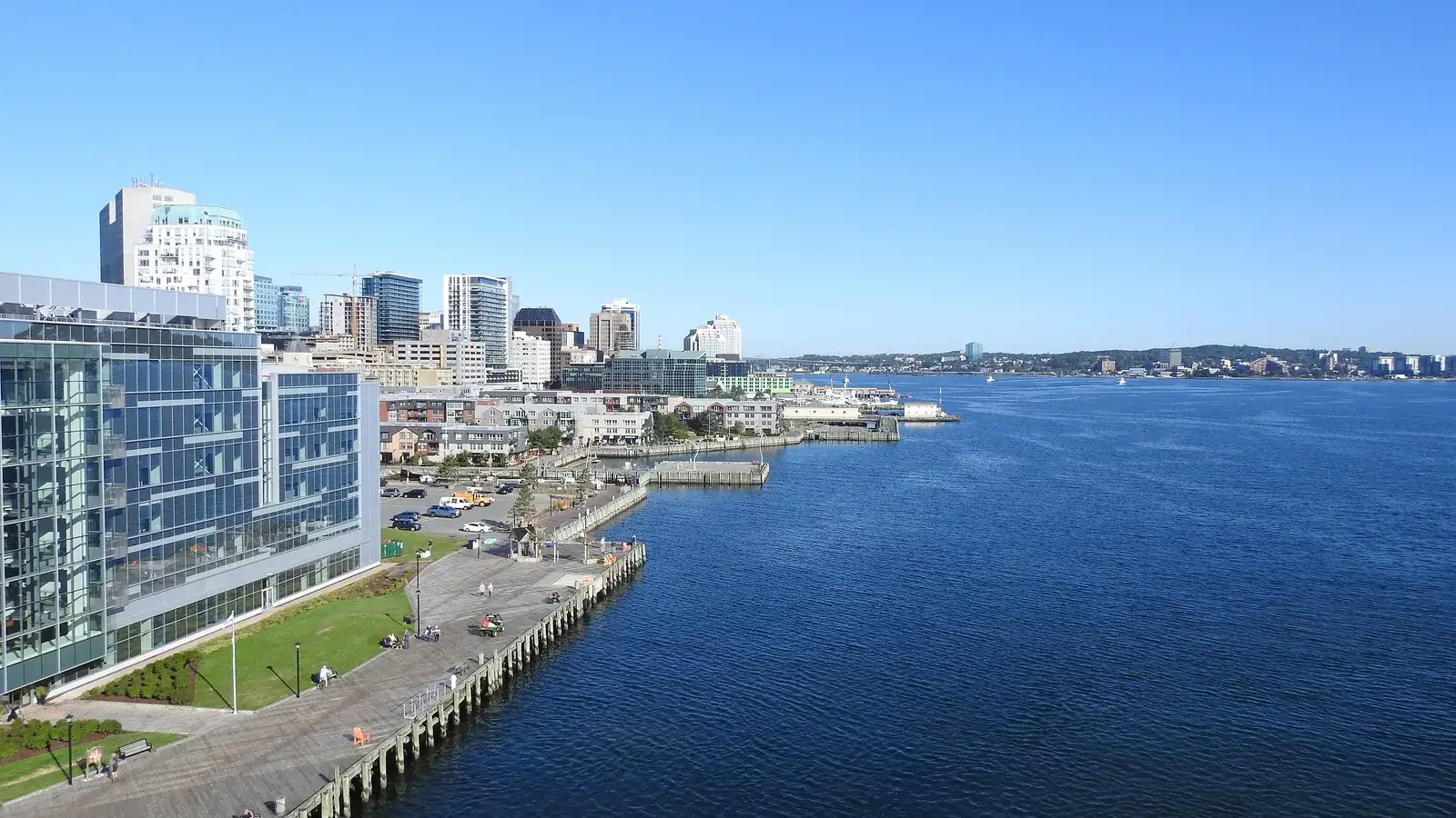 The Halifax boardwalk and downtown towers along the harbour with the Dartmouth shore across the water