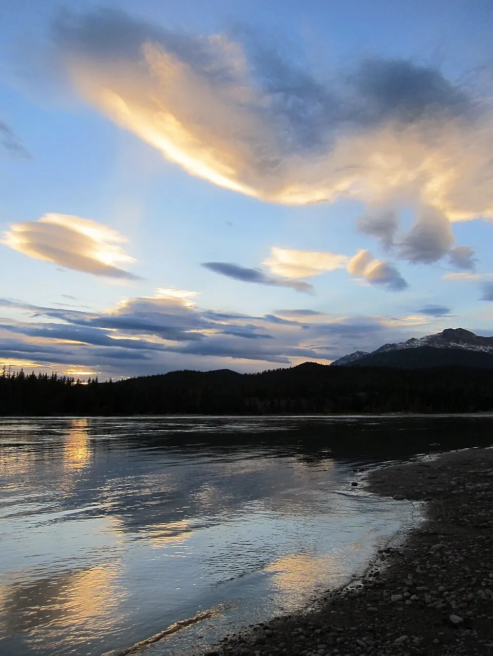 Sunset colours in the clouds over the Athabasca River near the Jasper townsite