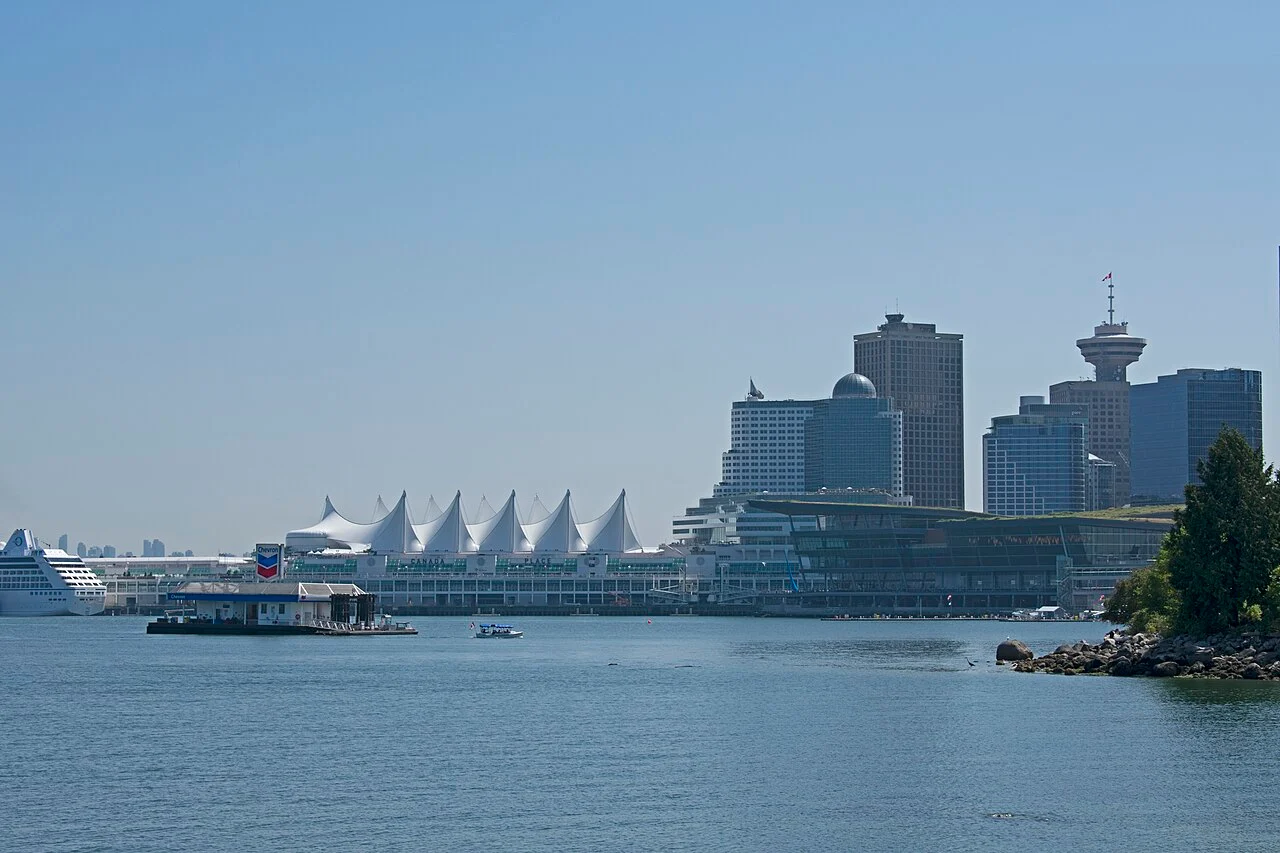 The downtown Vancouver waterfront and the white sails of Canada Place seen across the water from Stanley Park